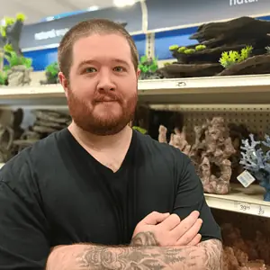 wesley oaks founder of betta fish bay in a pet store